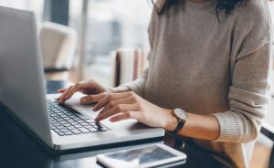 woman-using-laptop-setting-up-digital-profile