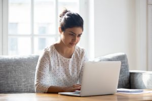 woman-using-laptop-to-search-digital-profile-management